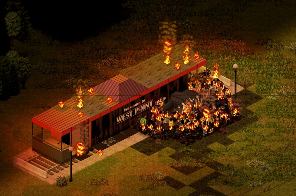 The "train car" diner in West Point, on fire, with a car beside it surrounded by zombies who are also on fire